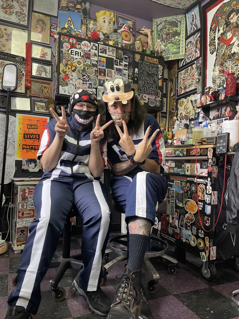 Participant and mentor strike a pose in matching anime outfits.